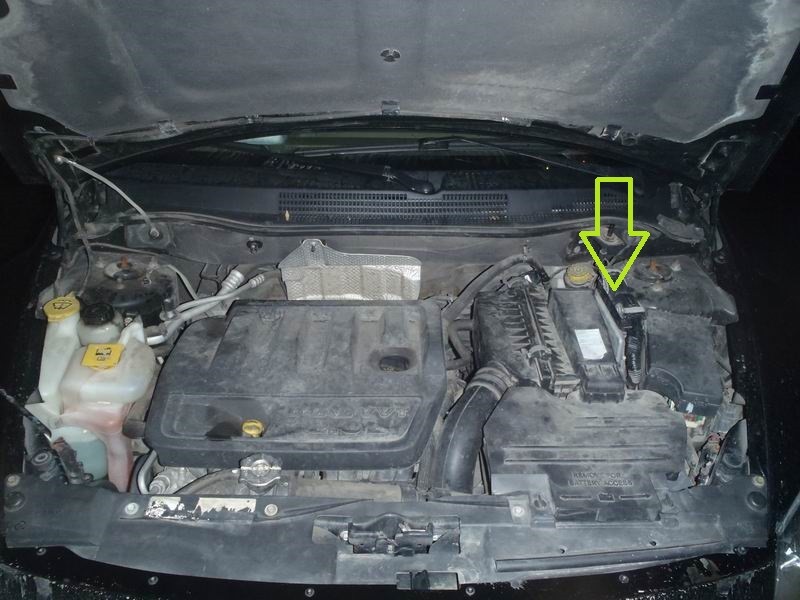 Блок управления двигателем (ECU) выделен на фото подкапотного пространства Dodge Caliber 2.0 зеленой стрелкой